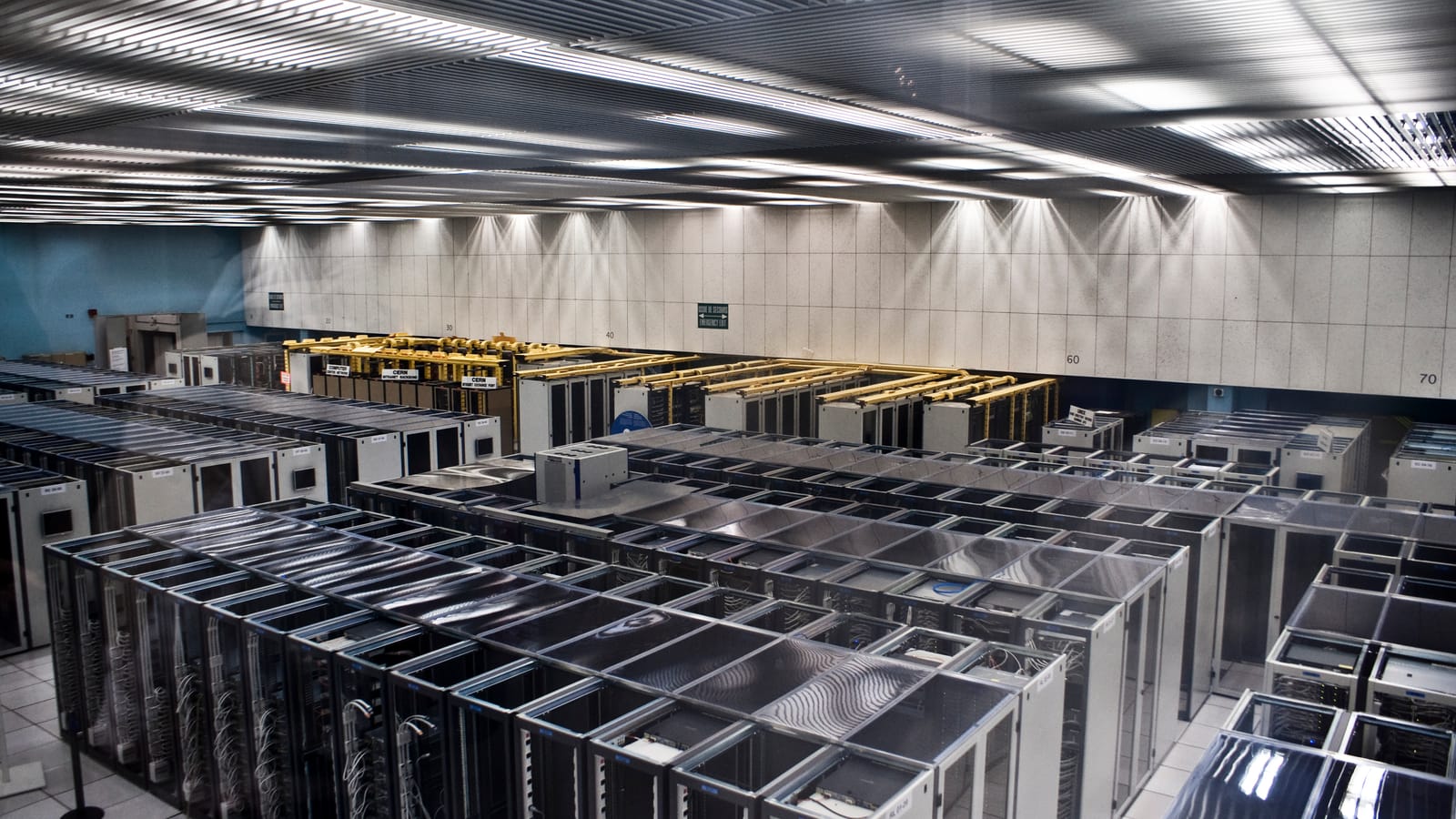 Rows of server cabinets in a large data centre hall
