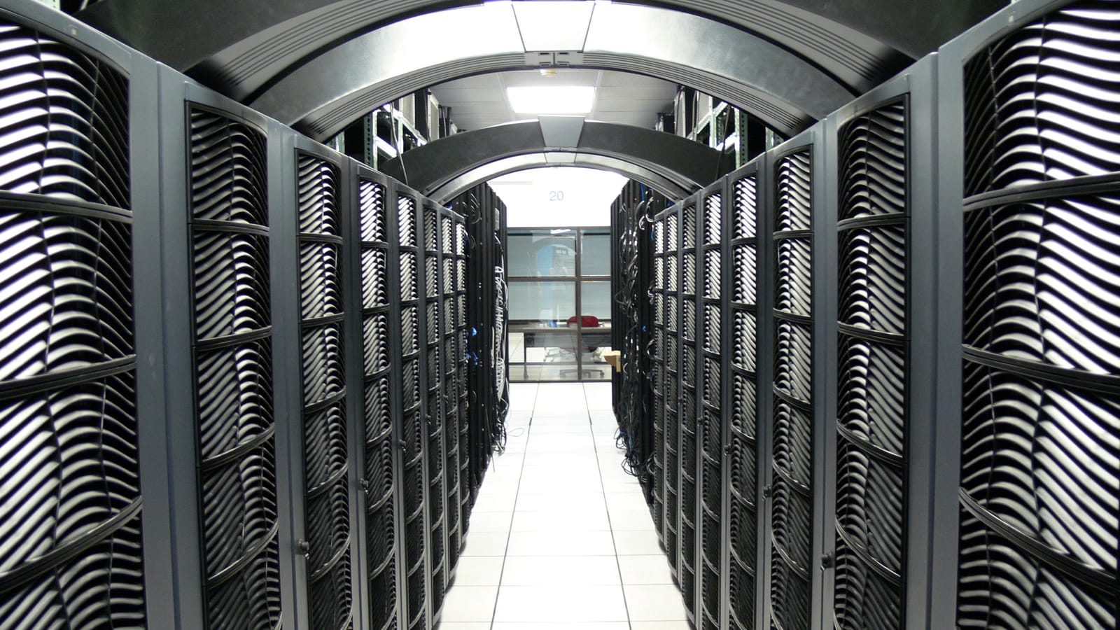 A long white-floored aisle between server racks